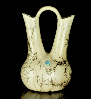 Cream-colored ceramic vase with twin handles, black crackle pattern, and a small blue accent on a black background