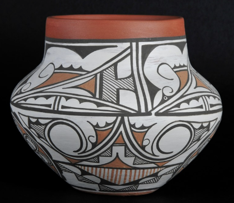 Decorative black, white, and orange painted pottery vase with geometric and bird motifs