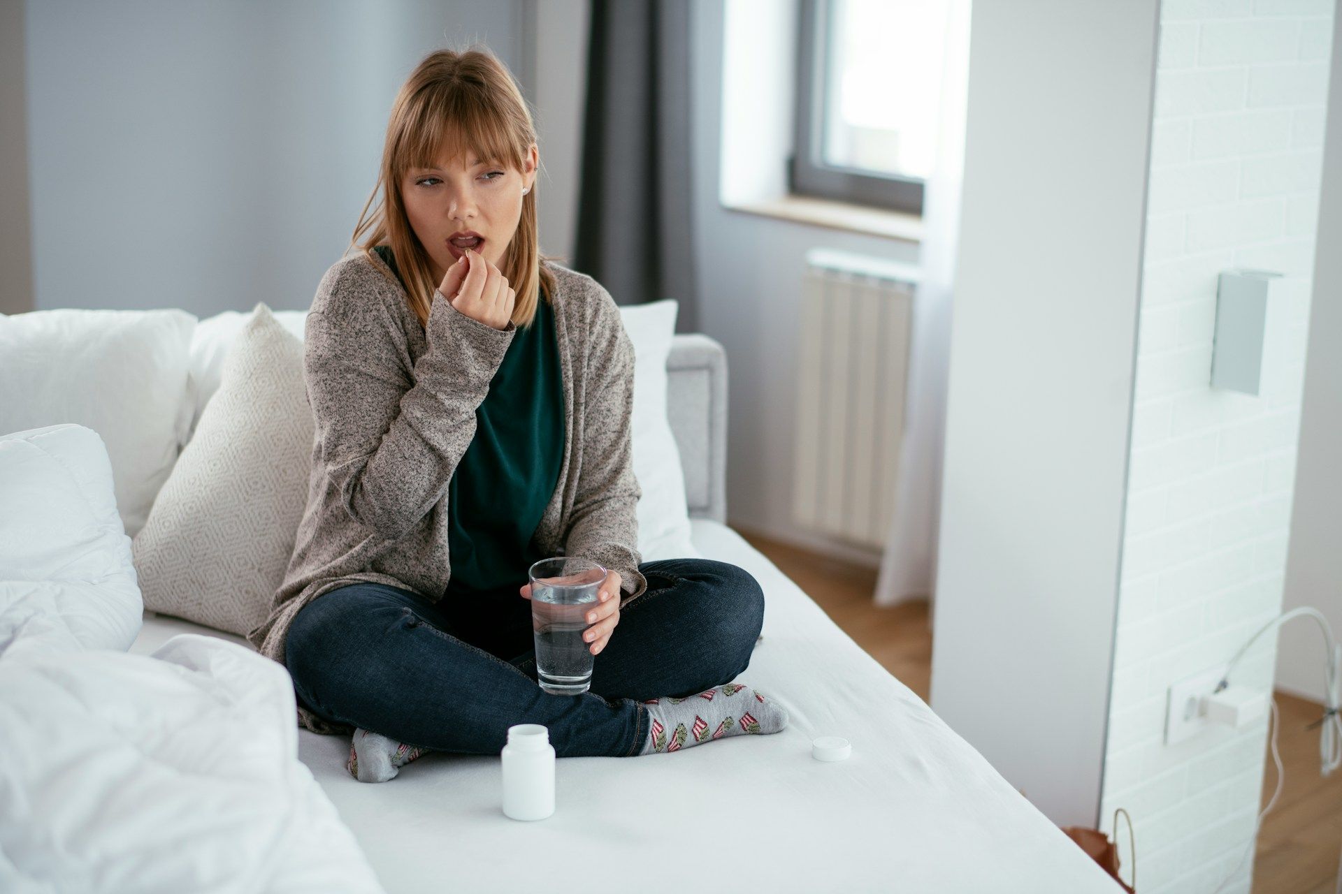 woman drinking medicine