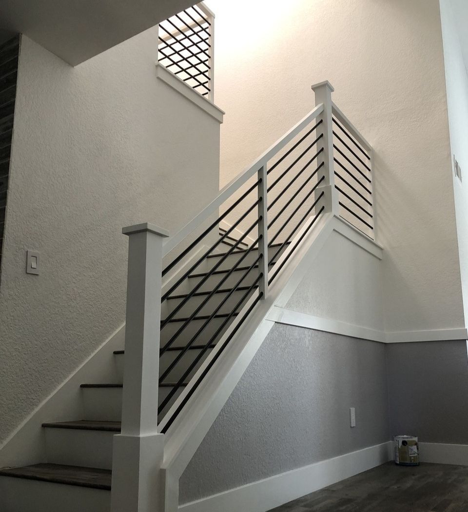 Modern Style Staircase Design in all white with square railing and square posts with flat post hat and horizontal black round bars