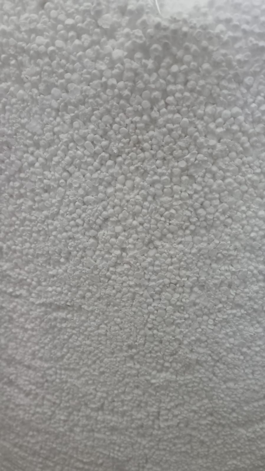 Close-up of white, spherical granules, likely styrofoam or similar material.