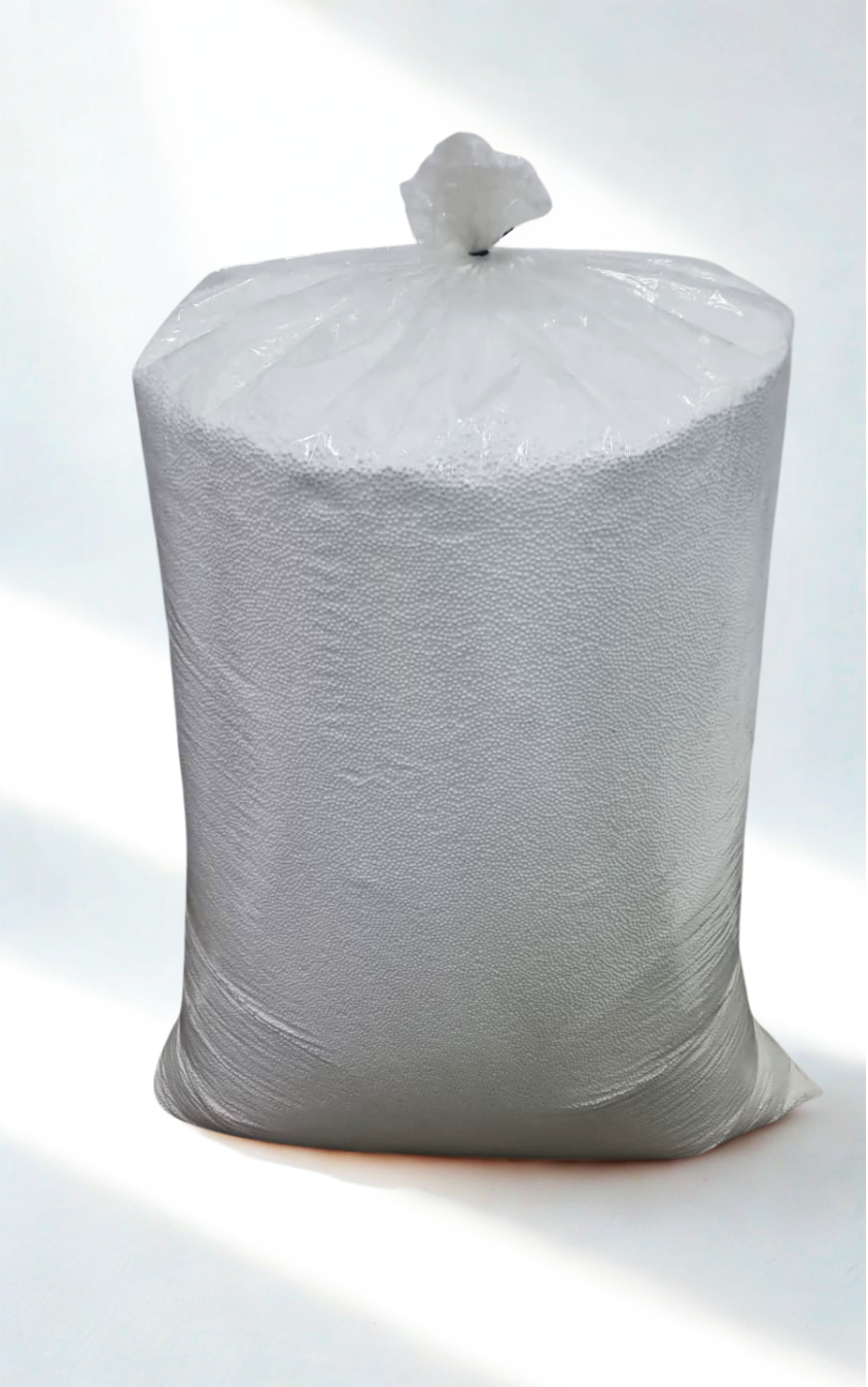 Bag of white, spherical packing peanuts, tied at the top, on a light background.