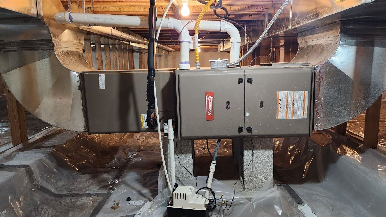 Basement HVAC furnace with ductwork and reflective insulation around it