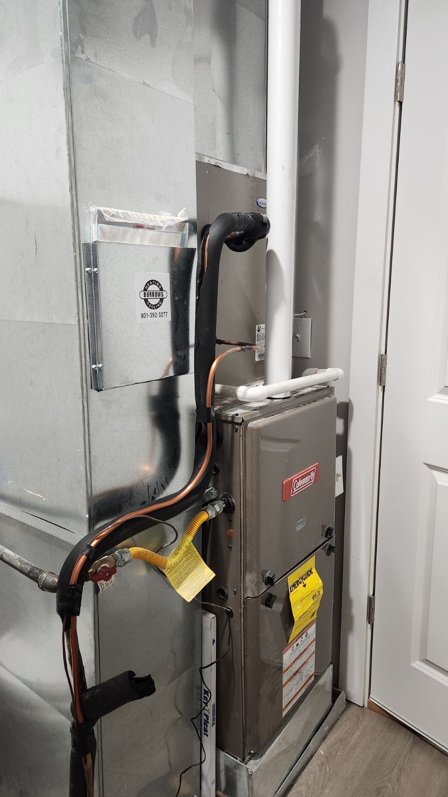 Residential electrical panel and wiring beside a door in a utility room