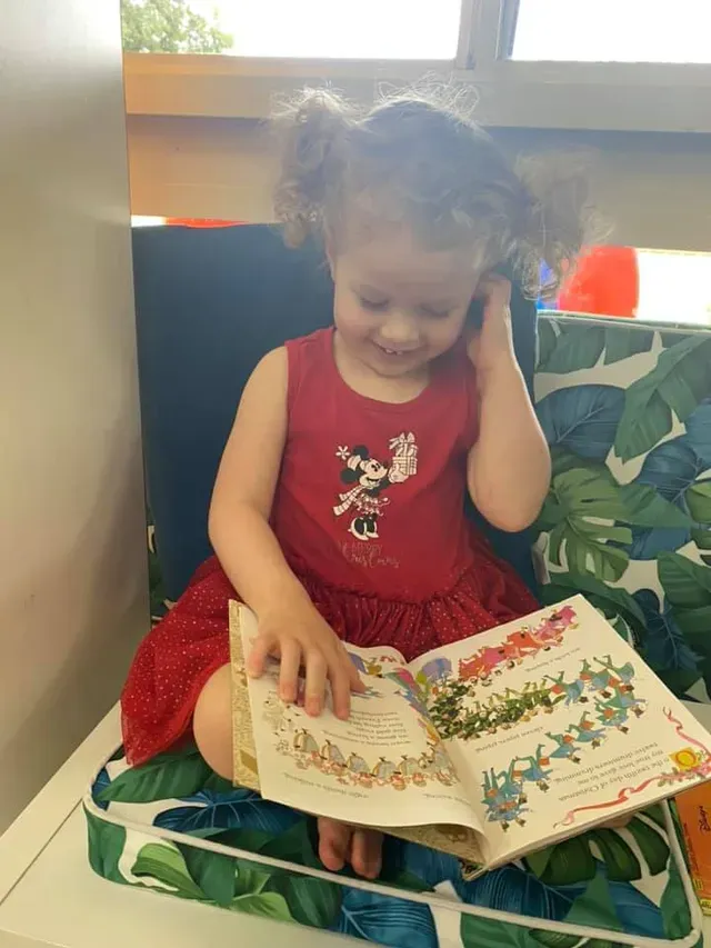 Girl Reading a Book — Goulburn, NSW — River Heights Child Care Centre