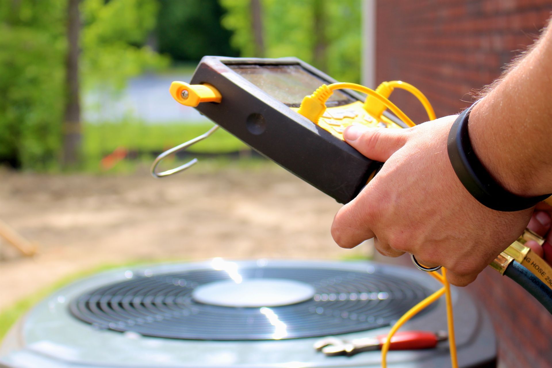 Technician repairing heat pump unit. Technician repairing heat pump unit.