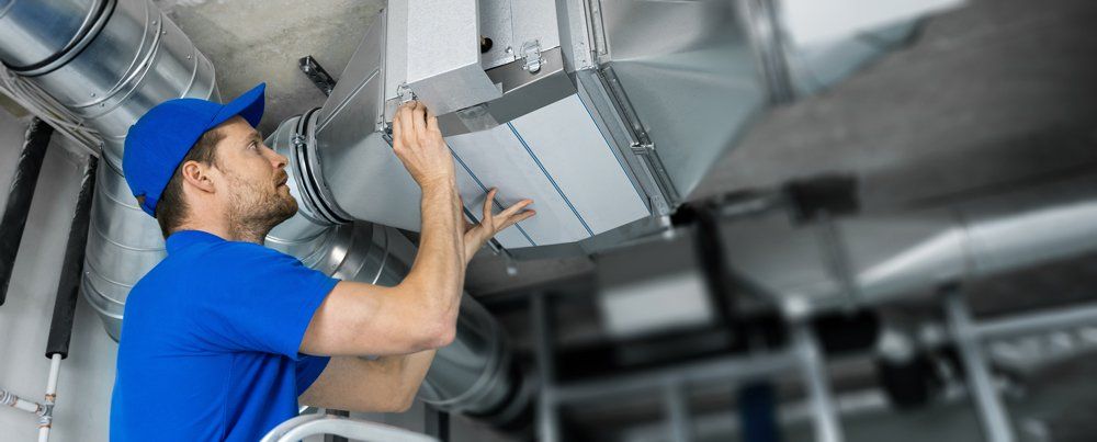 Worker Installing The Ventilation System - Elizabethton, TN - Creek's Climate Control