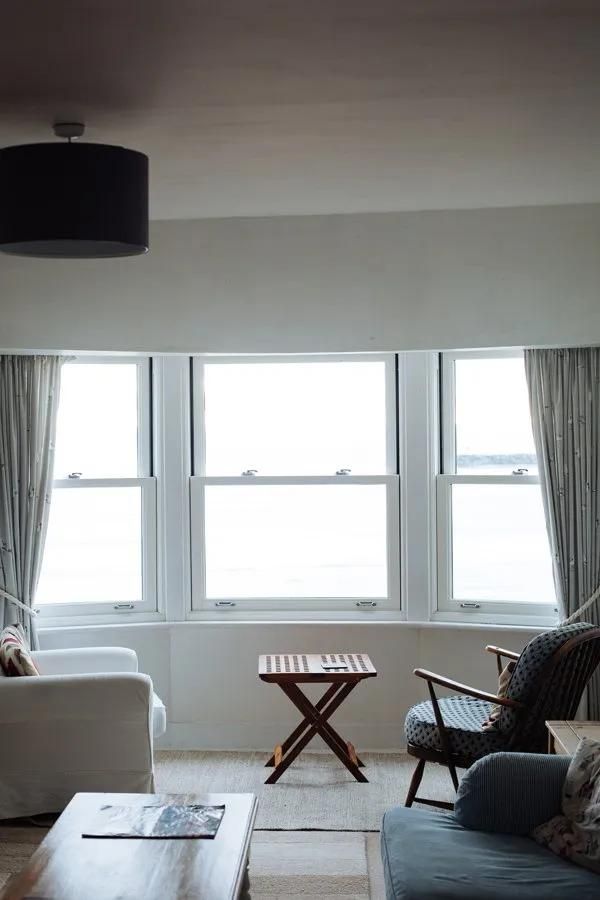A Living Room with A Couch, Chair, Table and Window — City Glass Newcastle in Maitland, NSW