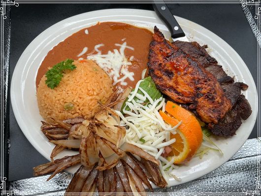 Plate of Mexican food: grilled meat, rice, beans, cheese, avocado, onion, and orange slice.