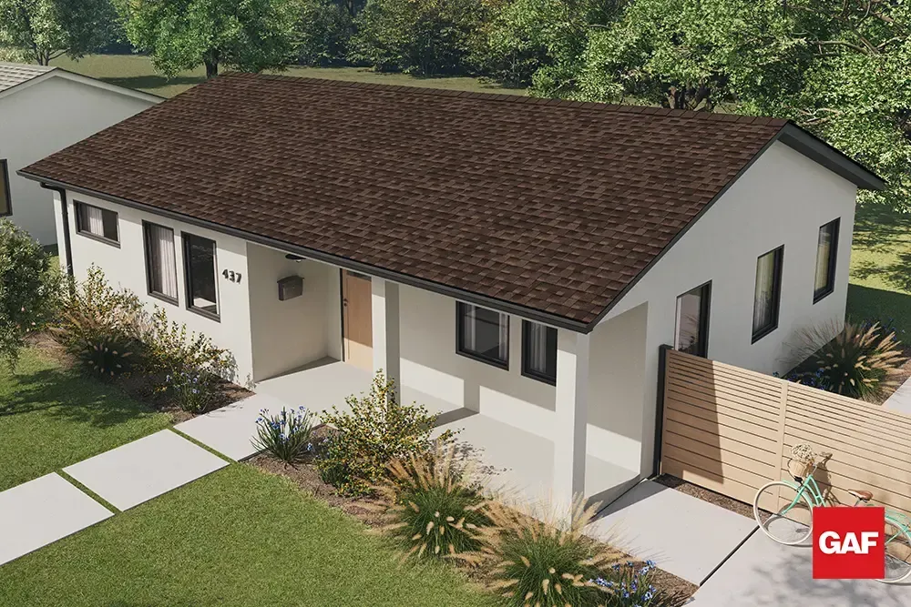 Single-story white house with brown shingle roof, front walkway, and landscaped yard