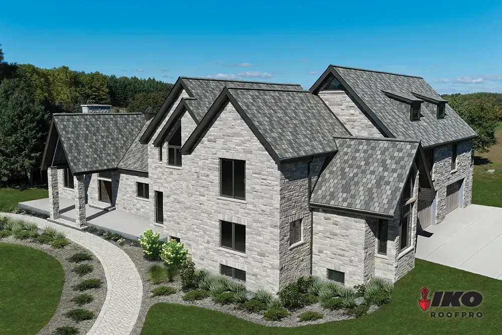 3D rendering of a large gray stone house with multiple gables, a curved driveway, and landscaped grounds