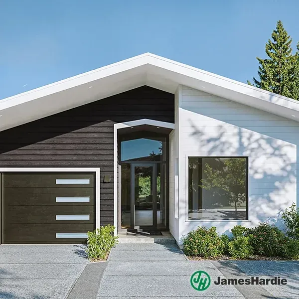 Modern house exterior with white and dark siding, garage, and landscaped front entry