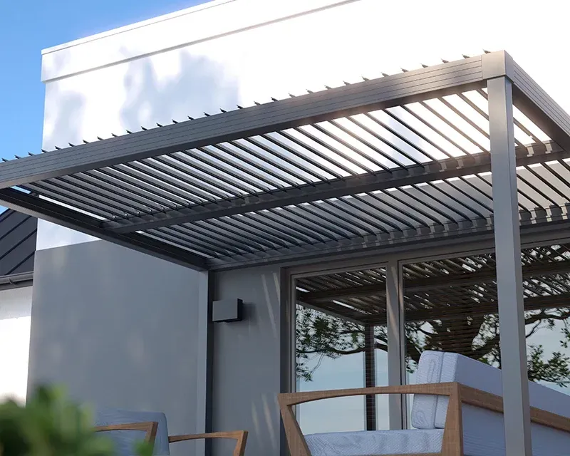Pergola shading a patio with gray furniture and glass doors.