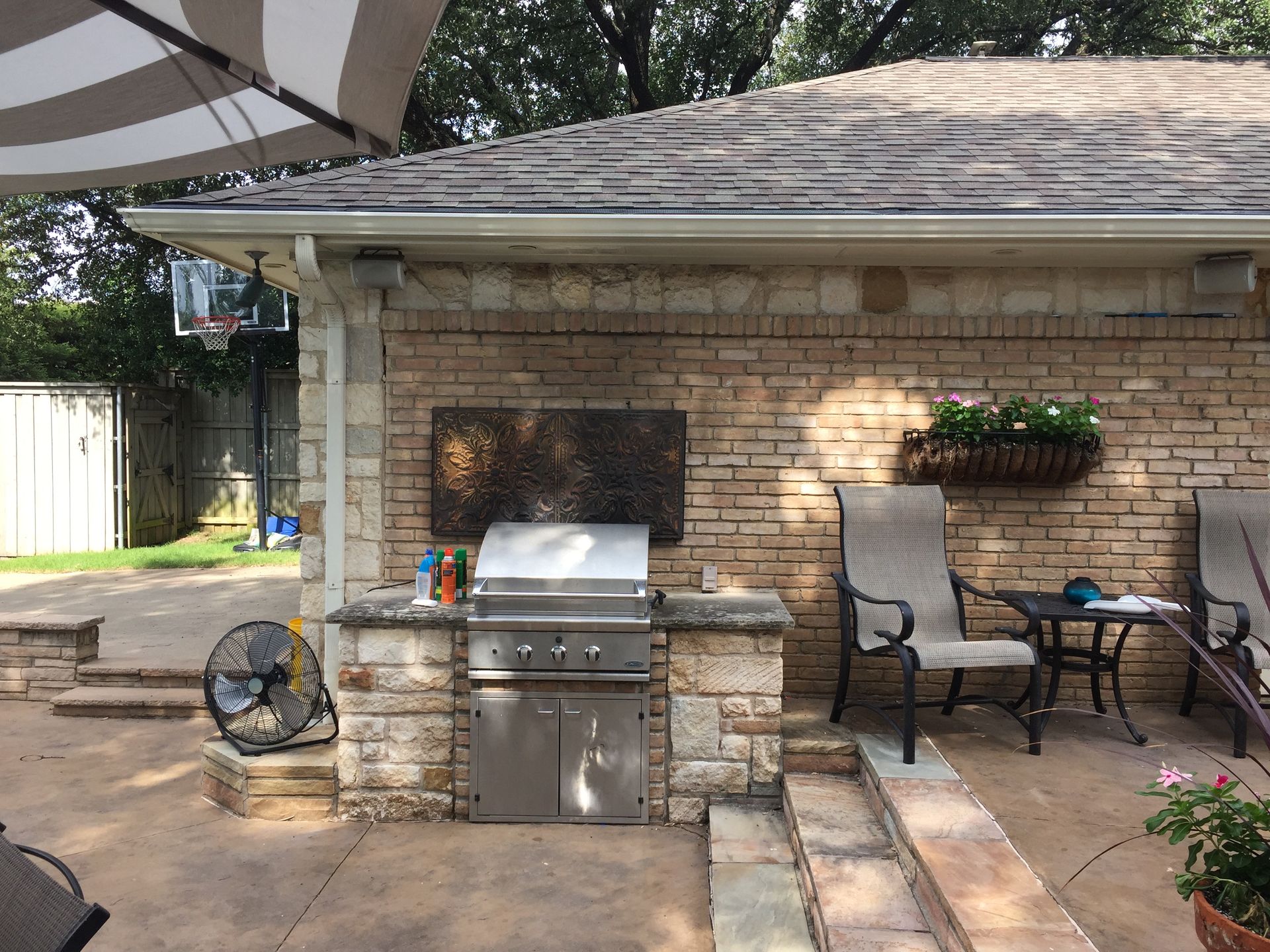 Outdoor stone fireplace with a large metal letter 