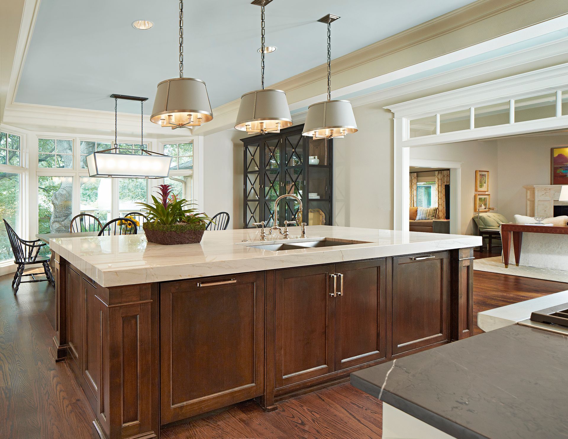 Spacious kitchen with blue island, stainless steel appliances, and white cabinets. Lakewood kitchen renovation.