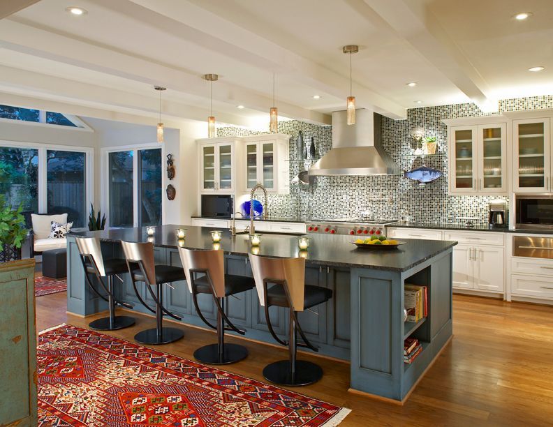 Modern kitchen with blue island and seating, white cabinets, and patterned backsplash. Richardson kitchen renovation.