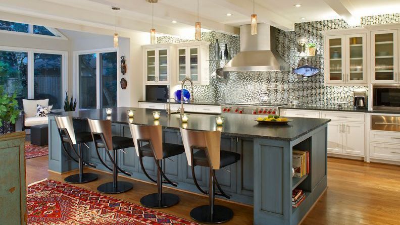 Spacious kitchen with blue island, stainless steel appliances, and white cabinets. Highland Park kitchen renovation