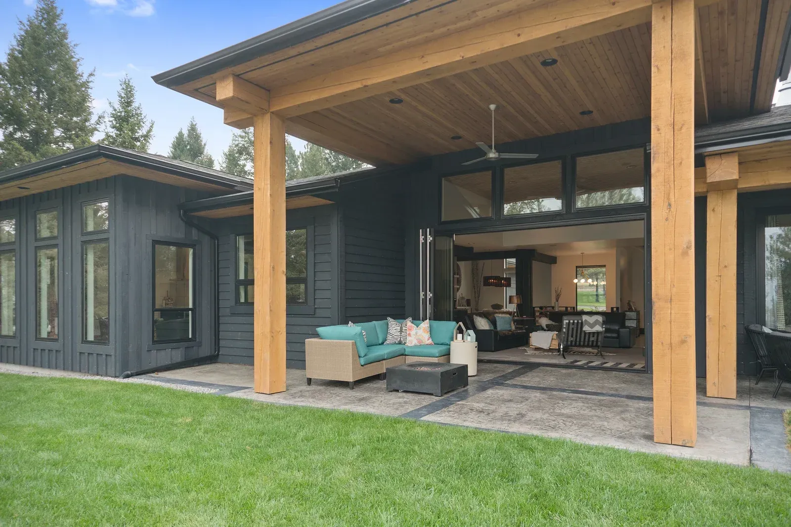 A large house with a patio and a couch in front of it.