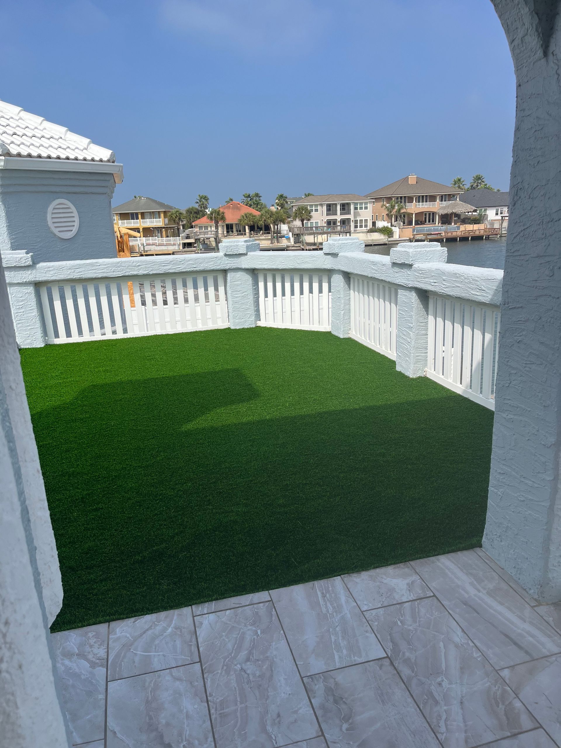A balcony with a lot of green grass on it