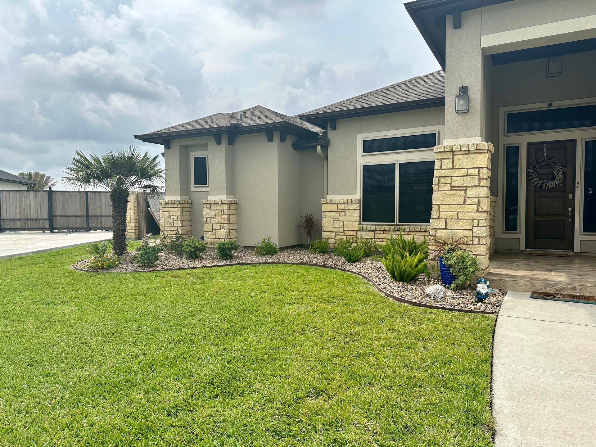 A large house with a lush green lawn in front of it.
