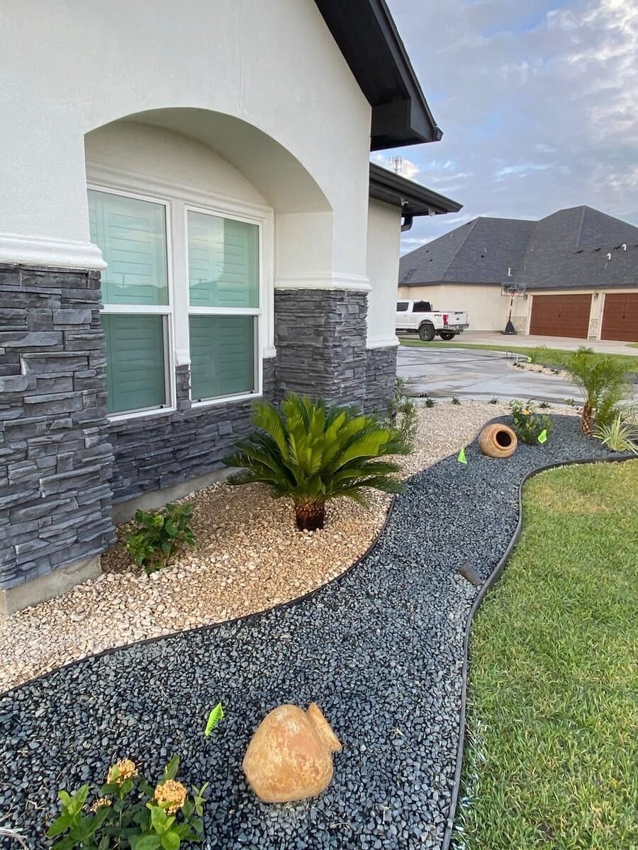 A rabbit is standing in front of a house.