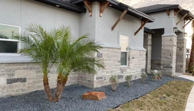 A house with a palm tree in front of it.