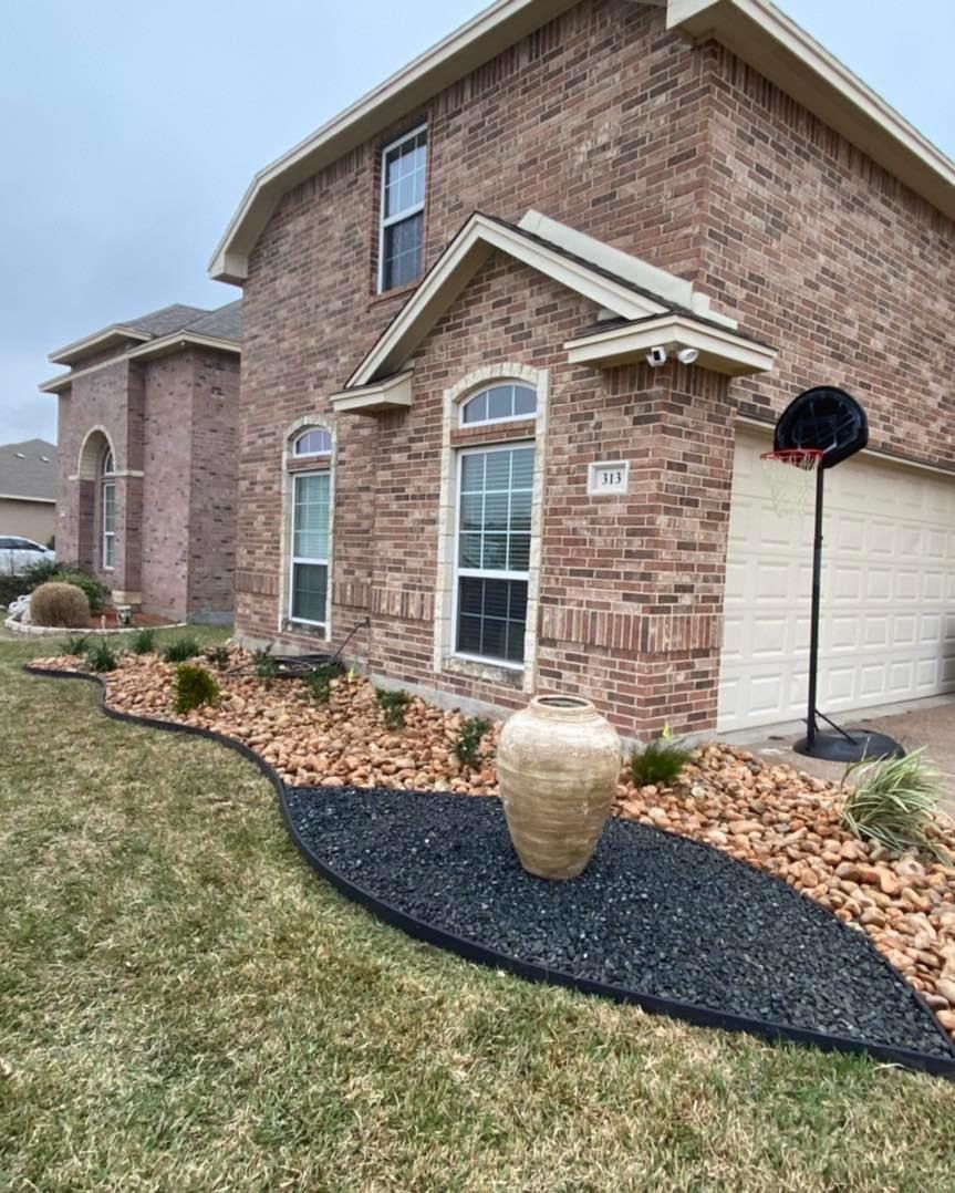 A large brick house with a lush green lawn in front of it.