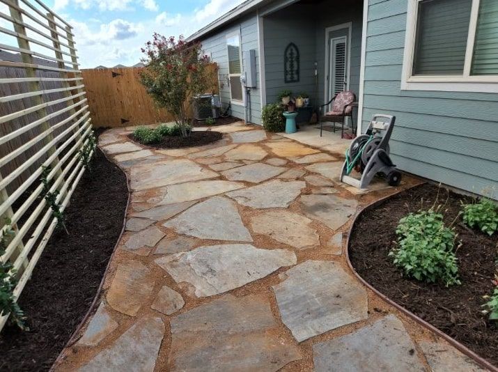 A stone walkway leading to the front door of a house.