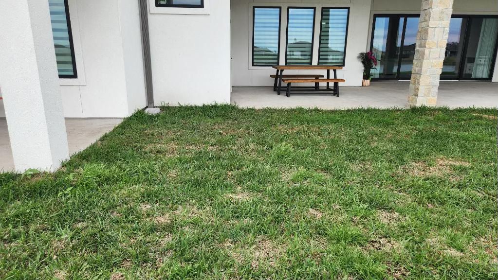 There is a picnic table in the backyard of a house.