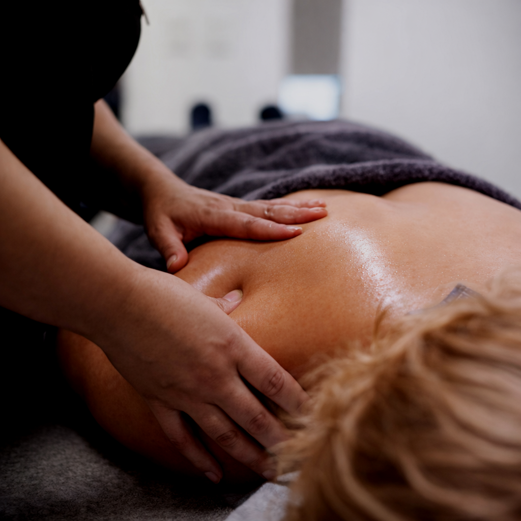 Physiotherapist performing trigger point therapy for shoulder pain