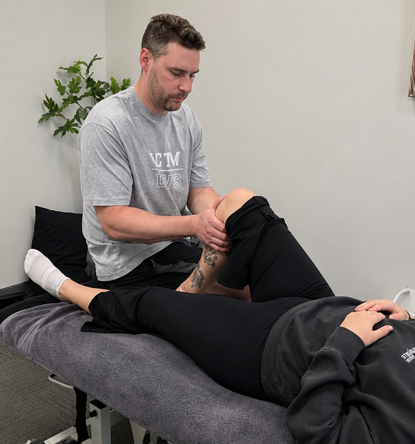 Physiotherapist performing trigger point therapy for neck and shoulder tension