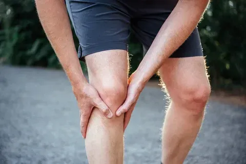 person holding knee in pain