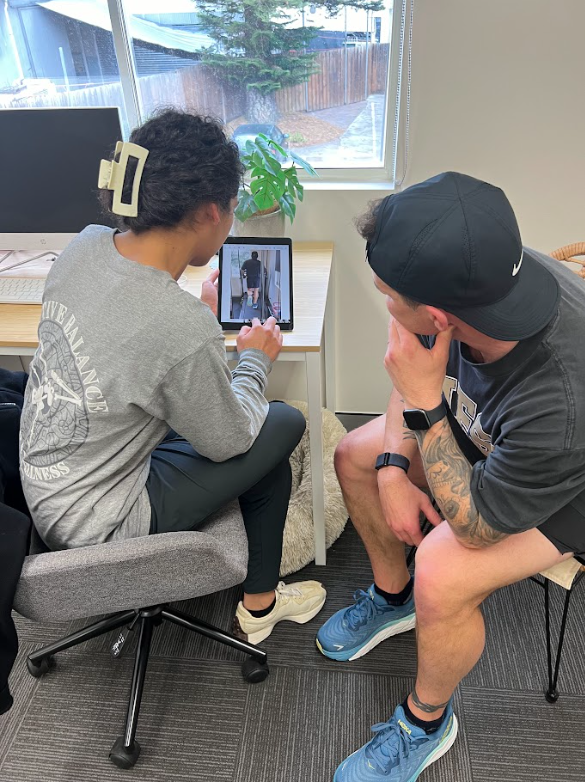 physio going through running analysis with client