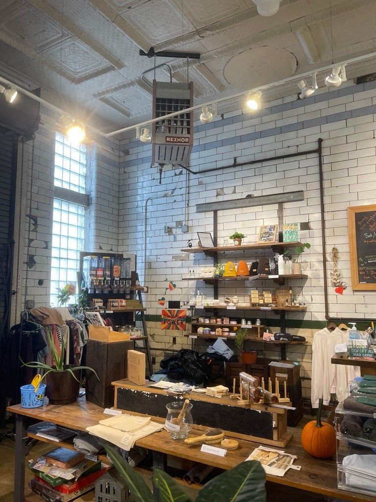 A room with a lot of shelves and a table with a pumpkin on it.