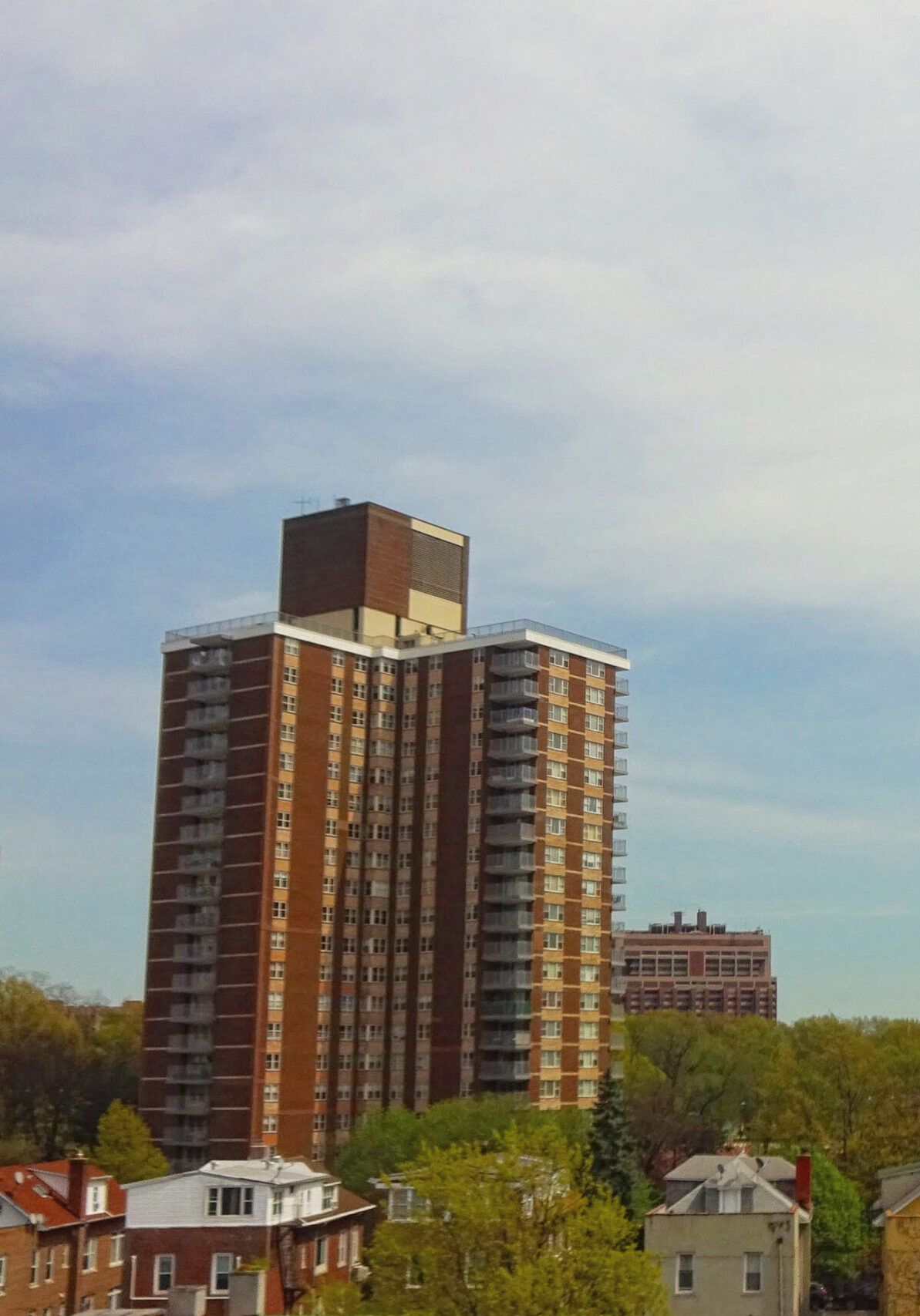 A tall brick building with a blue sky in the background