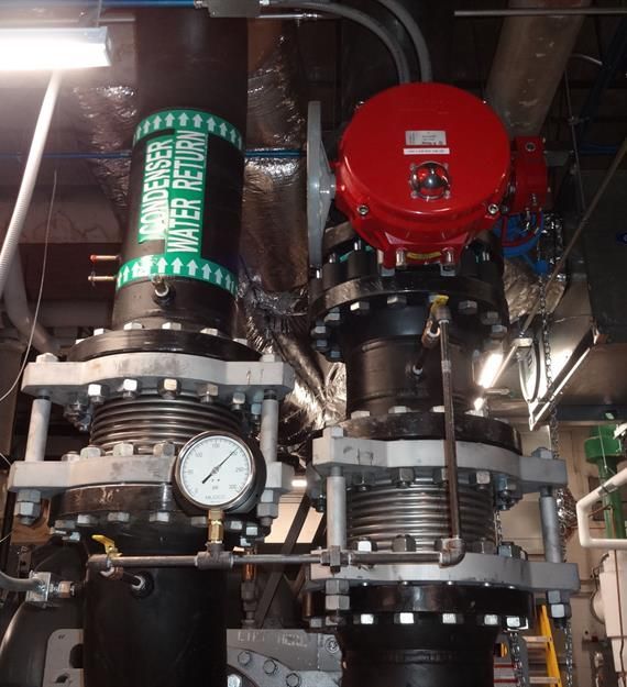 A red valve with a green label that says water return