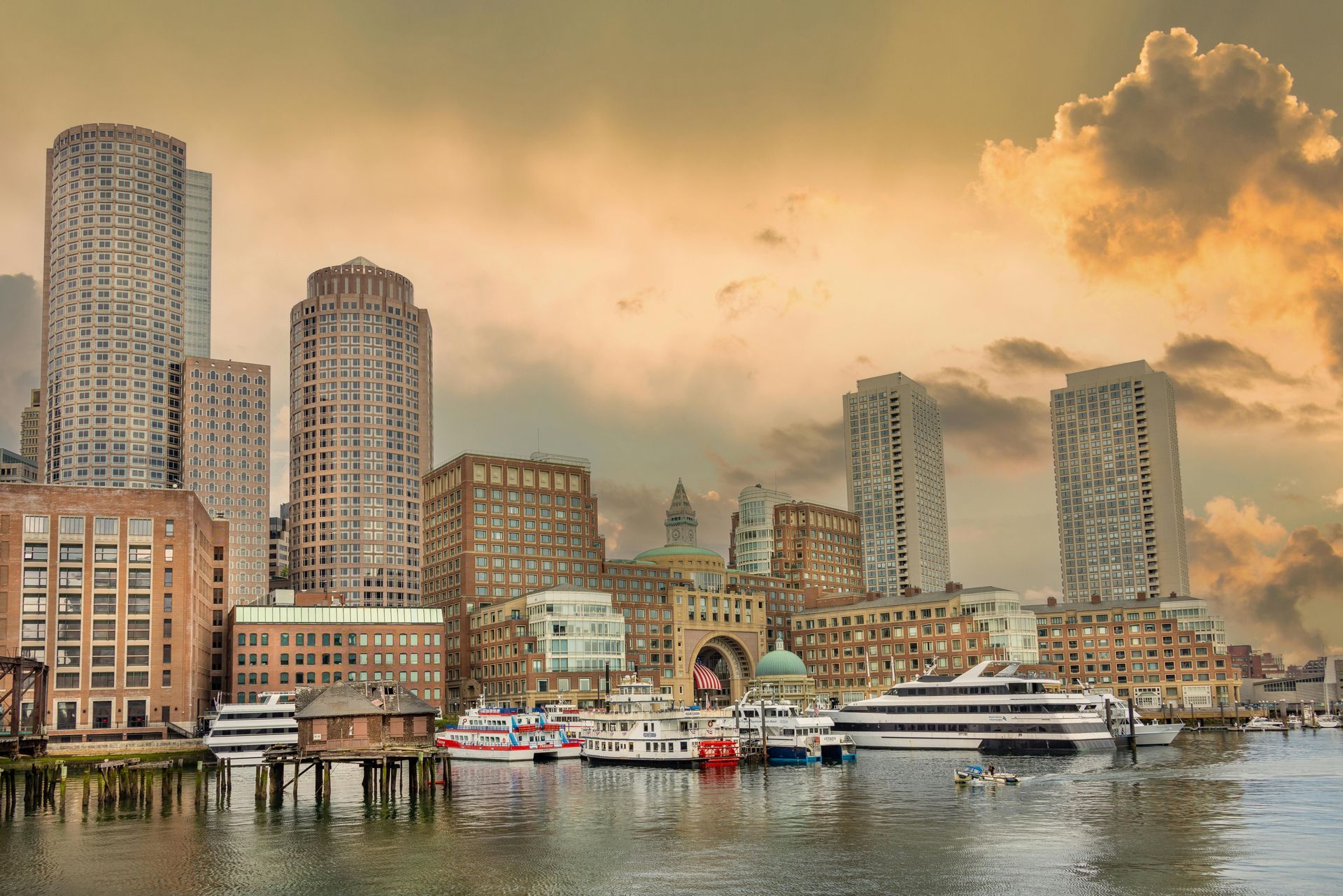 A city skyline with buildings and boats in the water