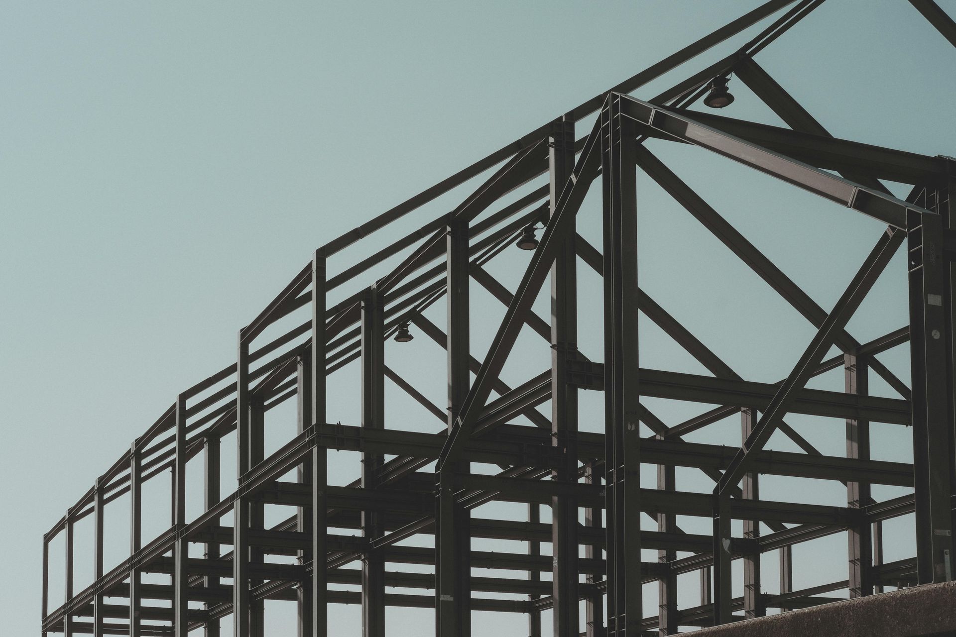 A building under construction with a blue sky in the background.