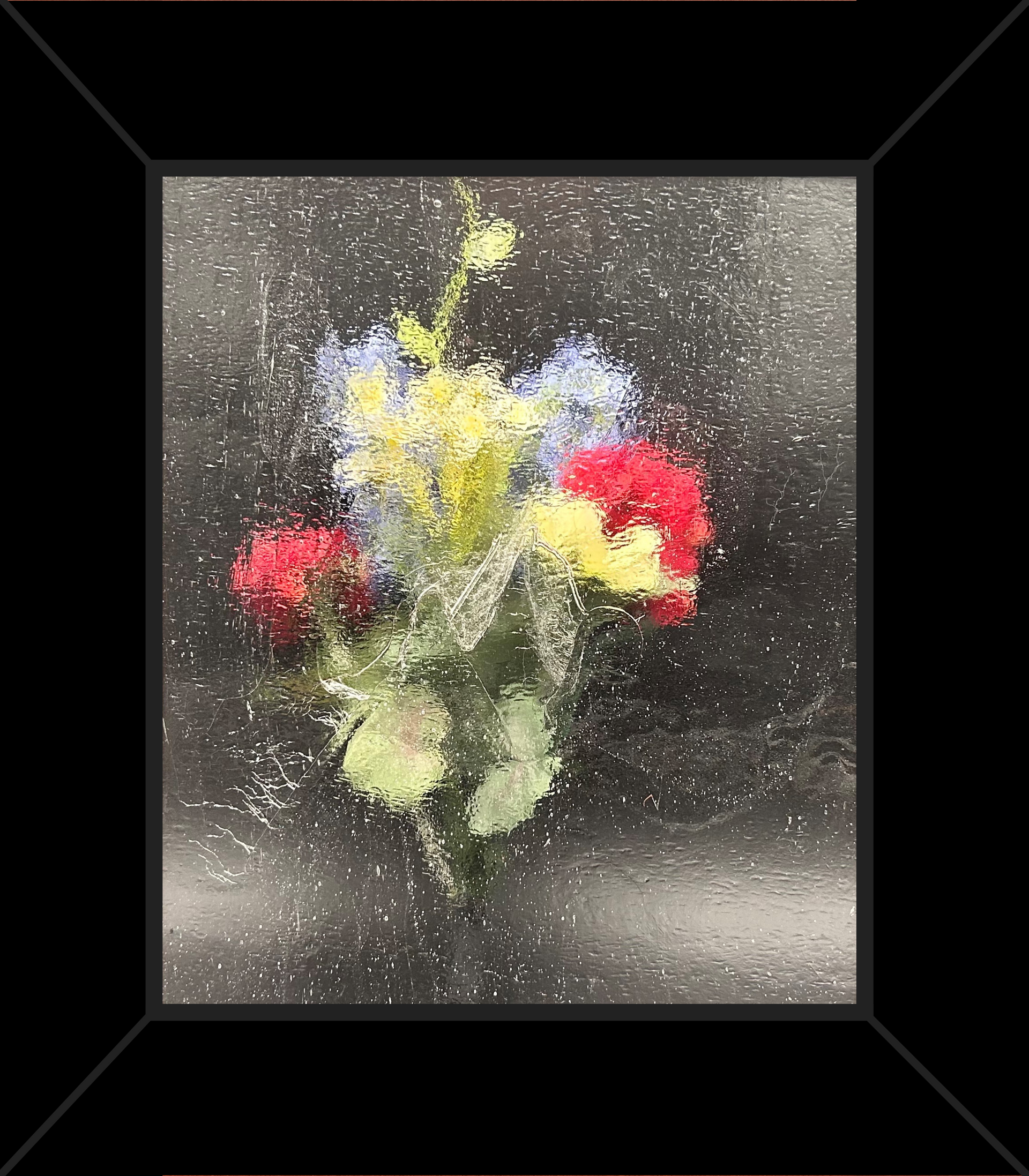 A framed painting of a bouquet of flowers on a black background.