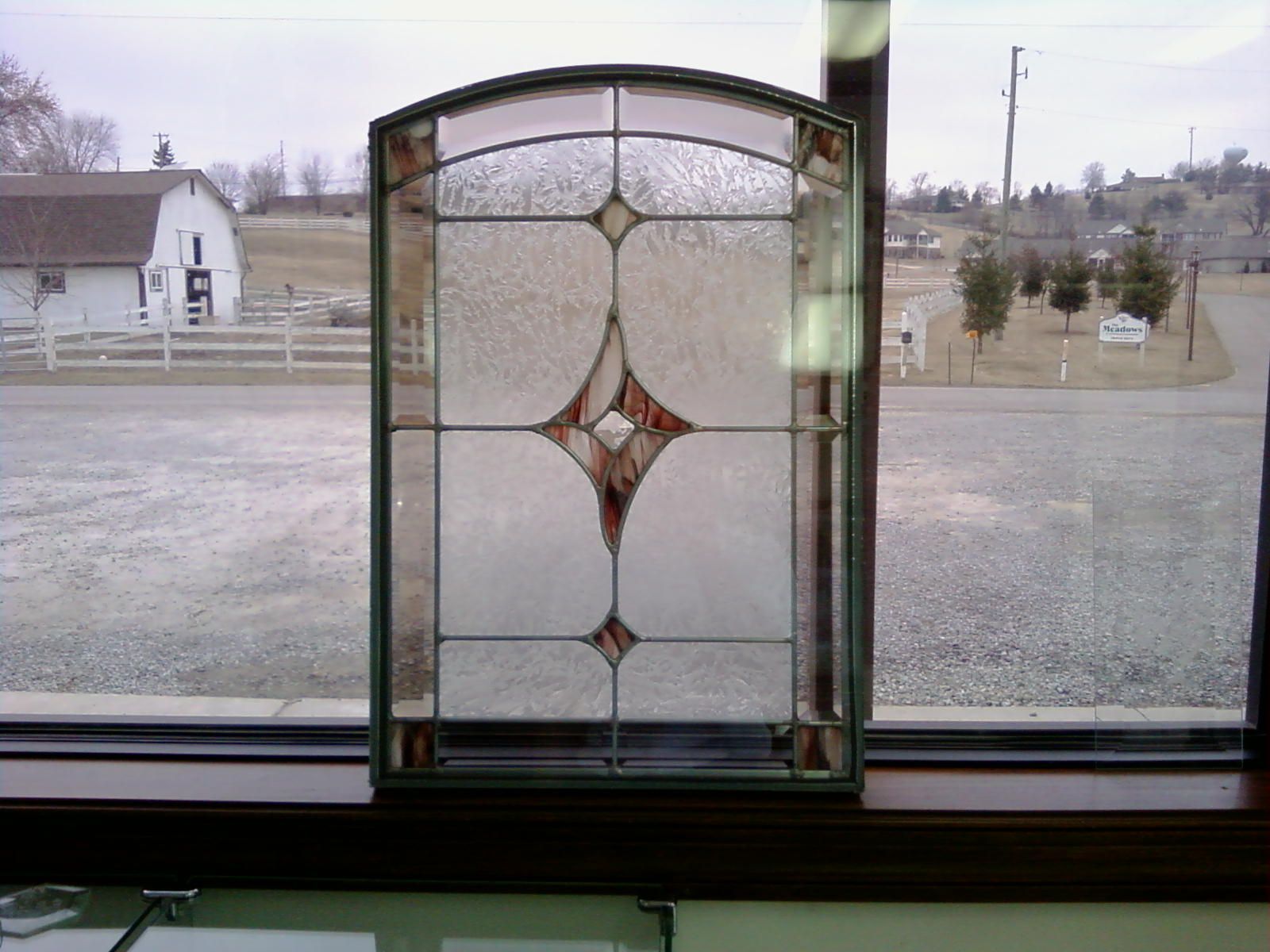 A stained glass window with a diamond design on it