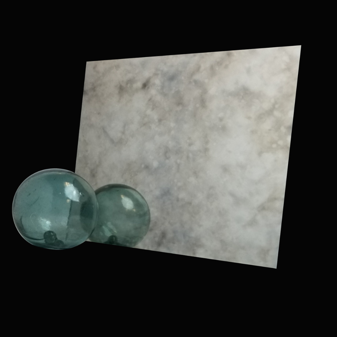 Two glass balls are sitting next to a piece of paper