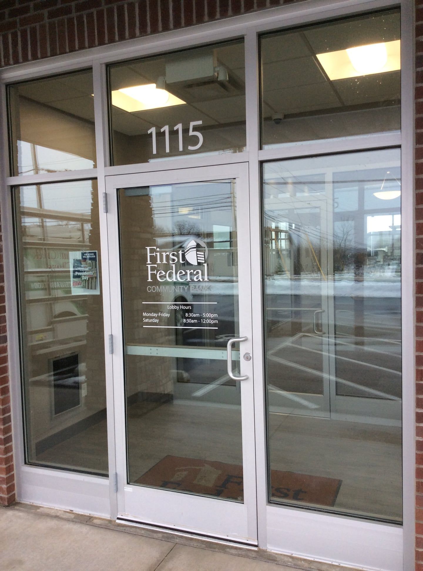 The front door of a building with the number 1115 on it.