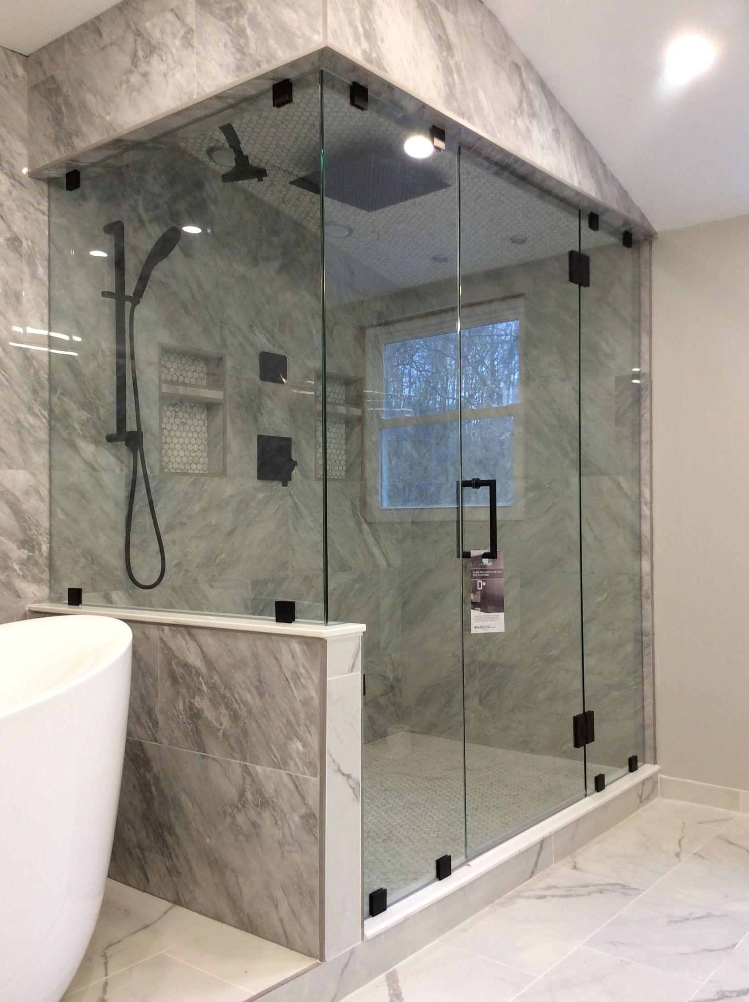 A bathroom with a walk in shower and a bathtub.