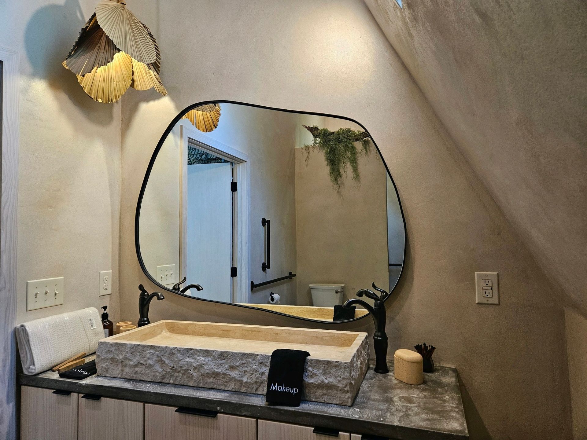 A bathroom with a sink and a large mirror.