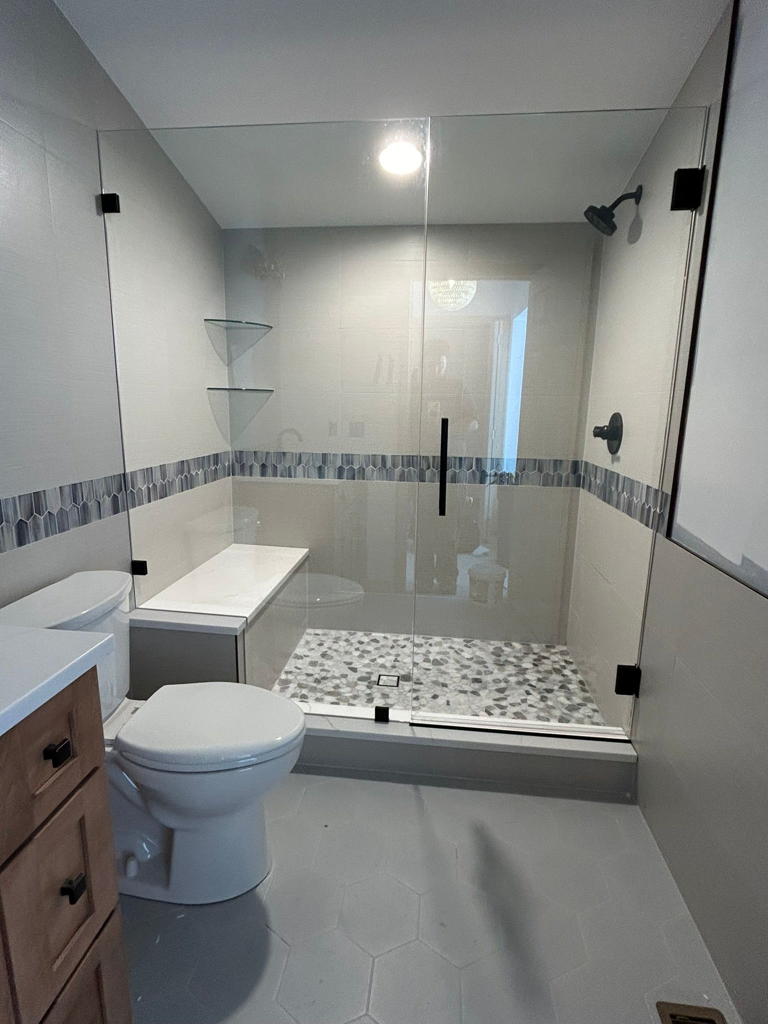 A bathroom with a toilet , sink , and walk in shower.