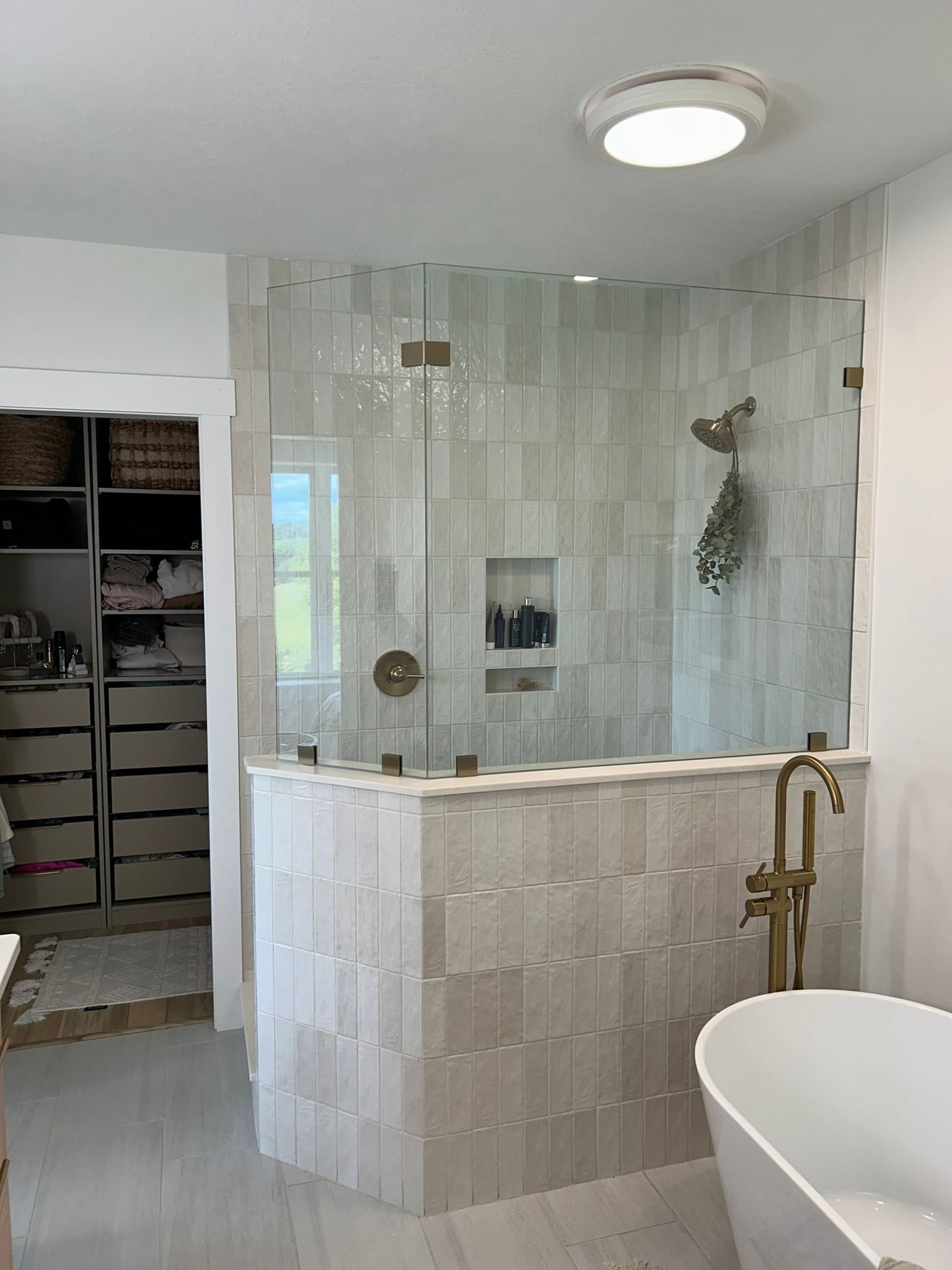 A bathroom with a walk in shower and a bathtub.