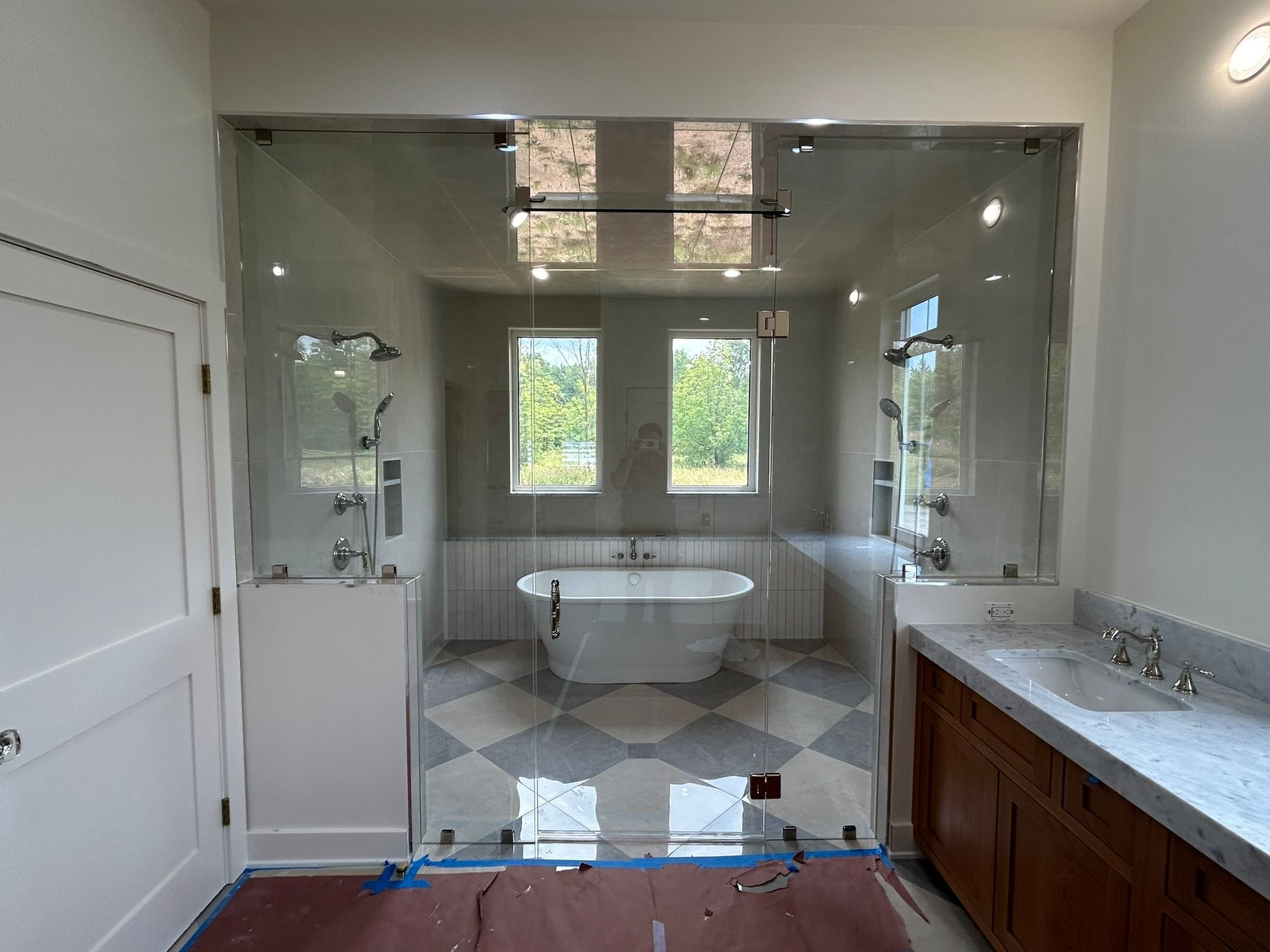 A bathroom with a bathtub , sink , and shower.