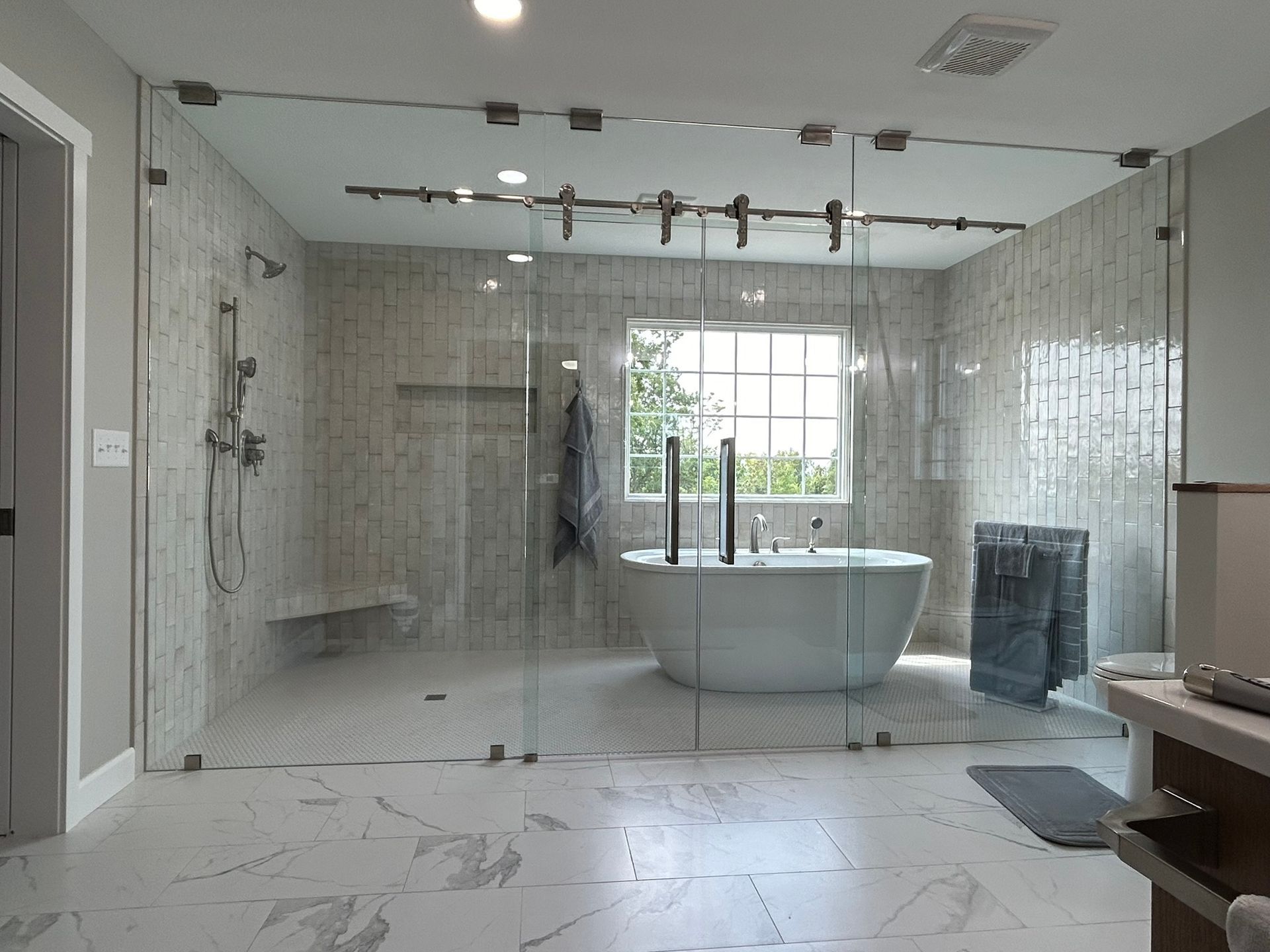 A bathroom with a bathtub and a walk in shower.