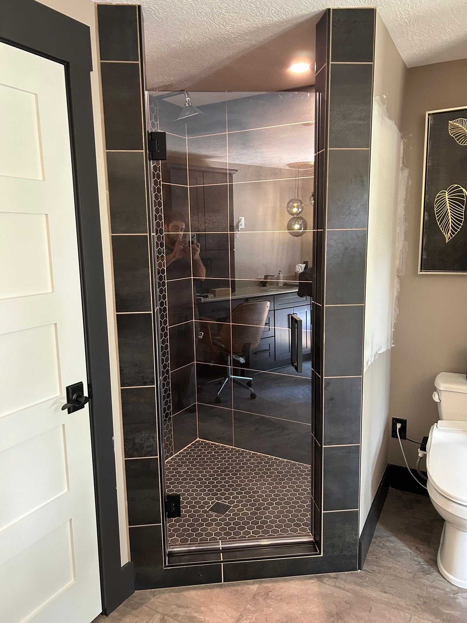 A bathroom with a walk in shower and a toilet.