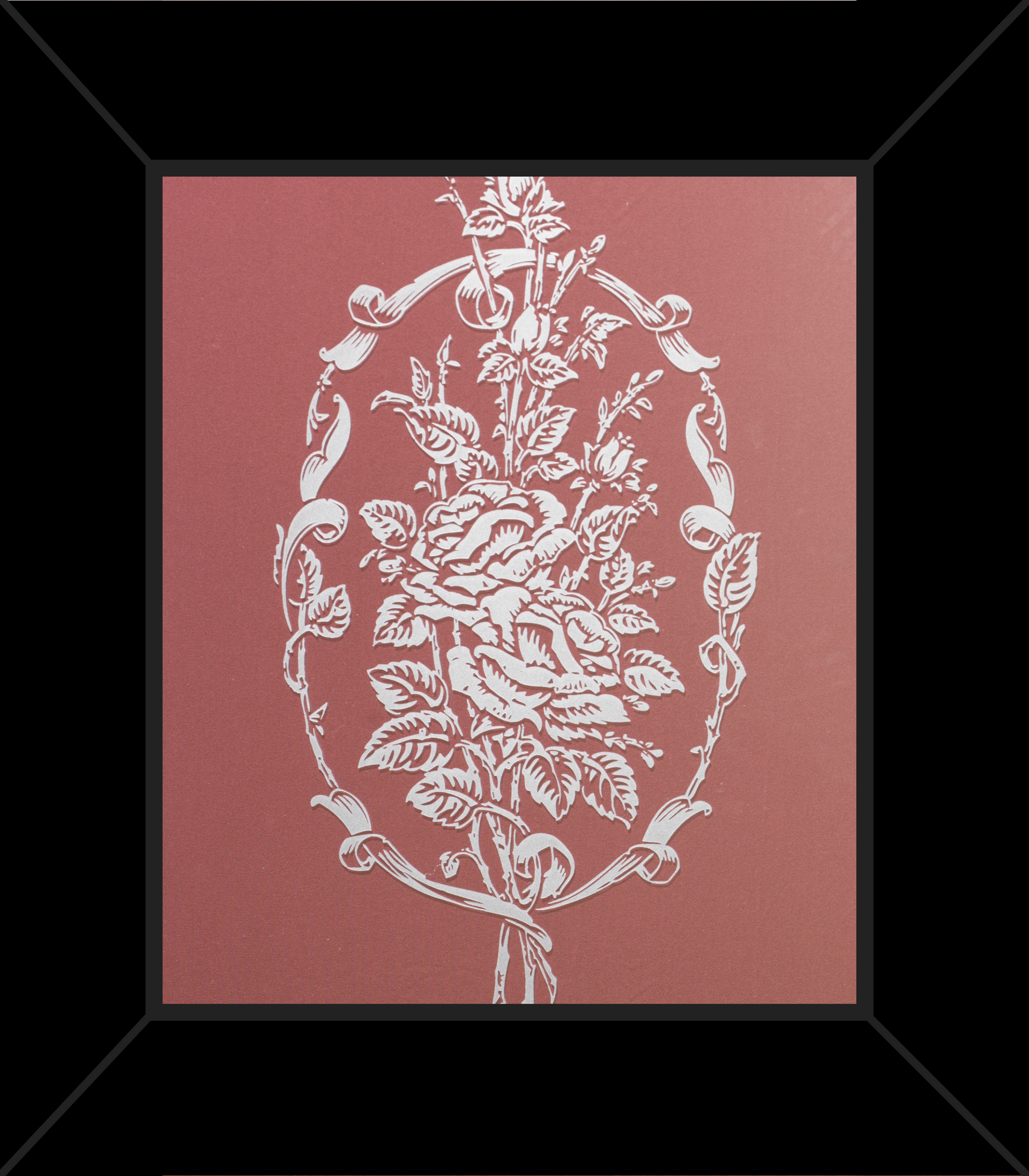 A framed picture of a floral design on a pink background
